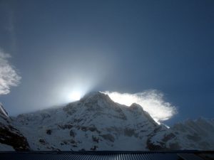 The sun dropping behind the mountains.