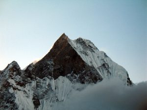 The stark contrast of icy rock and glowing sunshine.