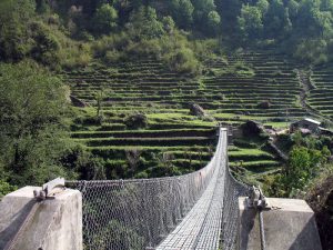 Bridge into lower Chomrong's terraced fields.