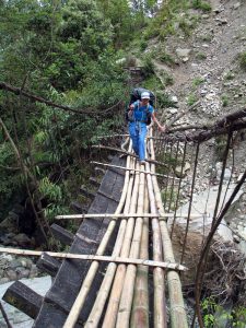 A broken bridge, repaired with bamboo logs.