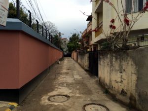 The long narrow alley leading to the gate of Goshen House.