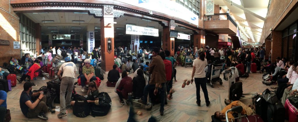 Inside the airport, at the ticket counters.