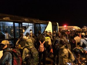 Travelers loading on to a shuttle bus to their flight.